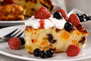 The cottage cheese casserole decorated with fresh blueberries and raspberry.Close up.