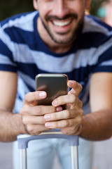 male traveler holding mobile phone