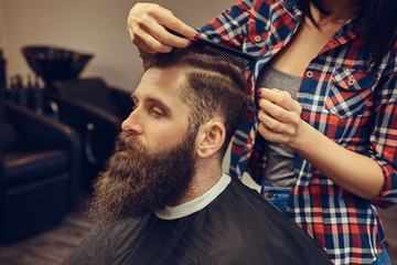 Handsome bearded man in the barbershop.