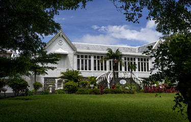 original colonial government white villa in a beautiful park on a green lawn on Mauritius Island