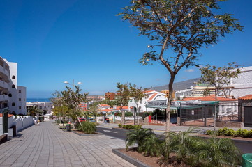 Fototapeta na wymiar Avda de Espana - street in the resort town Las Americas, in the west of the island of Tenerife, Canary Islands.