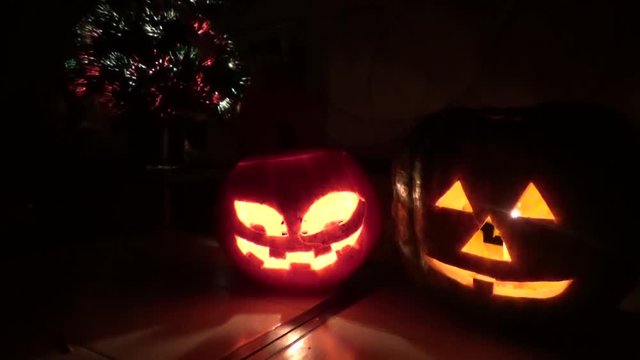 Two pumpkins with lights