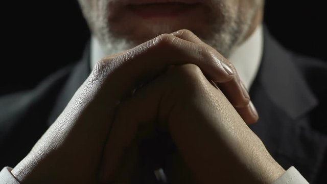 Adult businessman sitting at the table, thinking about campaign strategy closeup