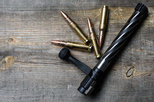 Shutter and ammo, lies  and on a wooden background.