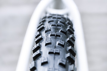 New and clean black mountain bike rear wheel detail and 29 x 2,2 tire close up, abstract with white background