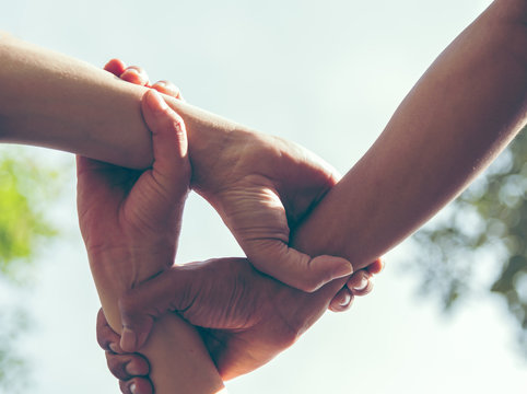Group of young sport team hands together, team partners giving fist bump come together for sport battle outdoor. Corporate teamwork partnership. Meeting,business concept,vintage tone.