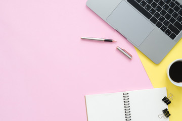 Creative flat lay photo of workspace desk. Top view office desk with laptop, blank empty notebooks and coffee cup on pastel color background. Top view with copy space, flat lay photography.