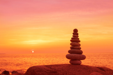 Fototapeta na wymiar Stones balance on a background of sea sunset. Concept of harmony and balance