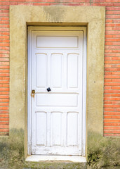 White door on brick wall