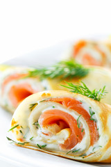 Pancakes with fish salmon, cheese and dill. Macro. Space for text