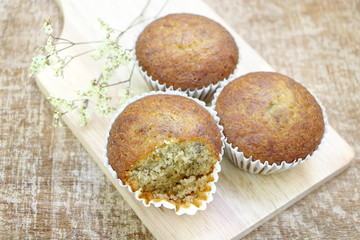 Close up group of many banana cup cake bakery on wood tray top view look soft and  delicious on wooden table background