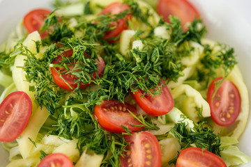 Salad from fresh vegetables sprinkled with dill. Raw food