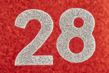 Number twenty-eight silver color over a red background. Anniversary
