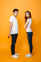 Full length image of Displeased Young couple looking at camera