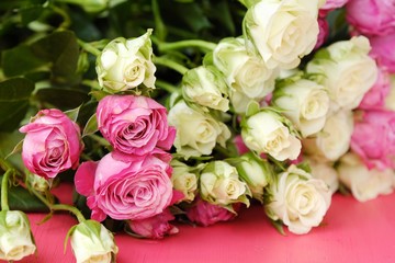 Beautiful bouquet of white and pink roses on pink background  