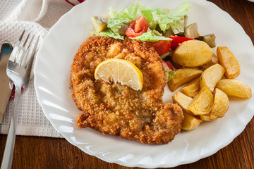 Breaded viennese schnitzel with baked potatoes