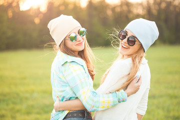Two young women spend time together outdoors. Best friends