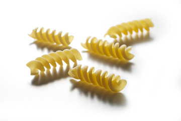 Five pieces of Fusilli pasta isolated on white background