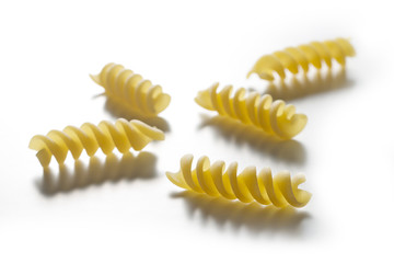 Five pieces of Fusilli pasta isolated on white background