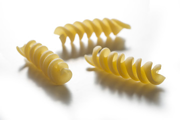 Naklejka premium Three pieces of Fusilli pasta isolated on white background