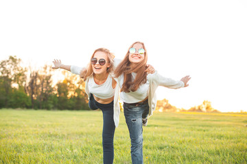 Two young female spend time outdoors.
