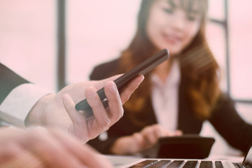 businesman analyze financial chart in smartphone . business team working with startup project. man & woman discussing market plan report at workplace. discussion, teamwork, collaboration