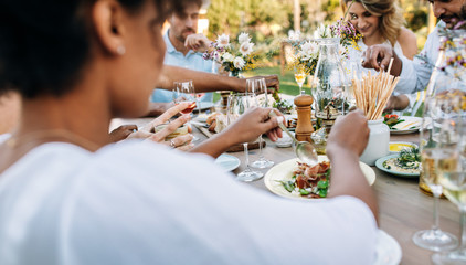 Friends having lunch together at outdoors restaurant