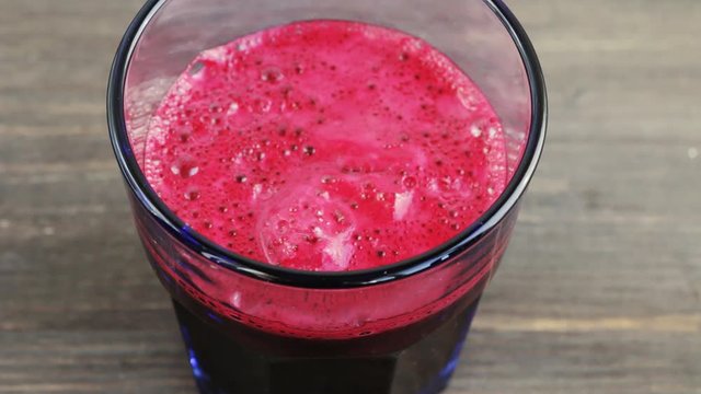 Fresh beet juice in a glass. Camera locked down. Concept of natural healthy organic drinks.
