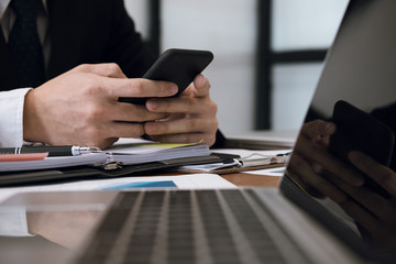 businessman holding smartphone & using app. man texting message at office. social network communication, wireless connection, lifestyle concept