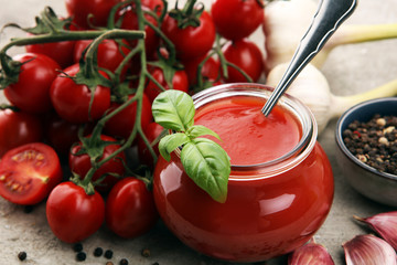 Fresh cherry tomato sauce on rustic background with cherry tomatoes.