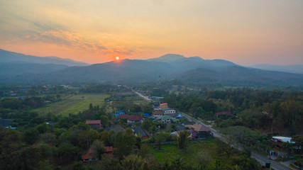 Fototapeta na wymiar aerial stunning beautiful sunset behind the great mountain in Chiang Mai
