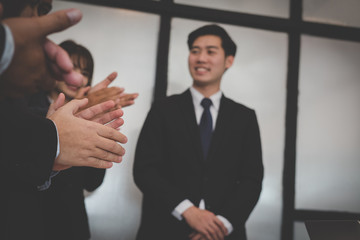 cheerful businessman applauding at conference. successful business team clapping hands for great work