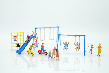 Miniature people : Children are enjoy playing together at the playground with many plaything use as children day concept.