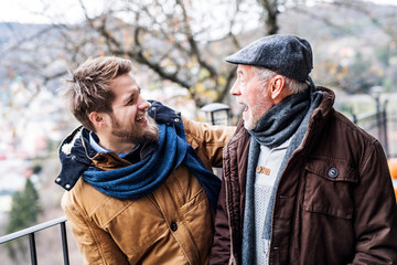 Senior father and his young son on a walk.