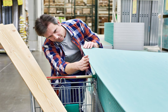 Man chooses and buys drywall in store