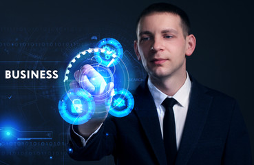 Business, Technology, Internet and network concept. Young businessman working on a virtual screen of the future and sees the inscription: Business