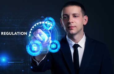 Business, Technology, Internet and network concept. Young businessman working on a virtual screen of the future and sees the inscription: Regulation
