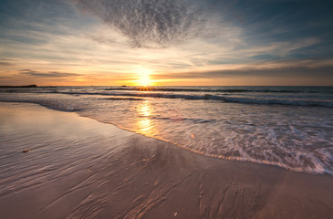 seascape  during golden sunset with waves trails.