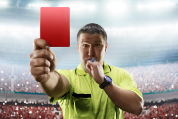 Referee showing the red card in the soccer stadium