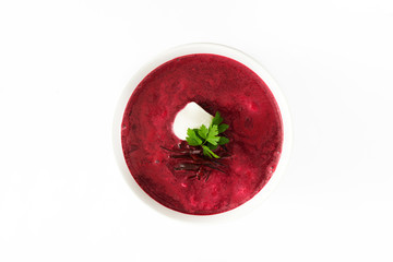 Beet soup in white bowl isolated on white background