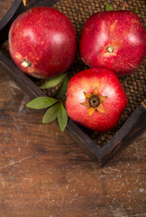 Ripe pomegranate fruits on the wooden background
