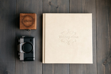White leather wedding album, wooden box with inscription Wedding day and vintage photo camera