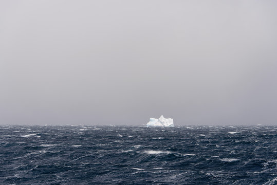 Iceberg in stormy Antarctic sea