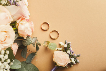 Wedding bouquet and gold rings, closeup