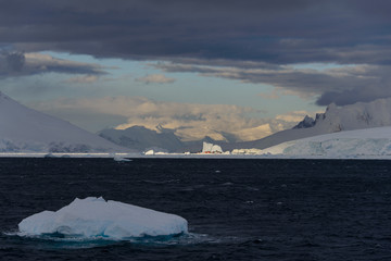 Fototapeta na wymiar Iceberg in stormy Antarctic sea