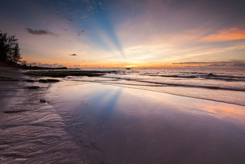 seascape with ray of light and reflection. image contain soft focus and blur due to long expose.