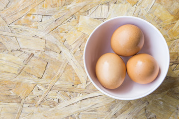 top view of eggs in bowl, egg on the table, copy space for text.