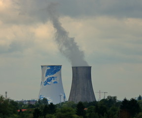 power plant on background of blue sky, smoke up from one