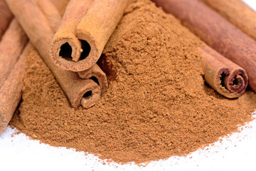 Cinnamon sticks and powder on white background