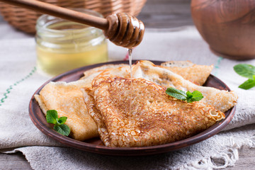 Russian traditional pancakes with yeast and honey